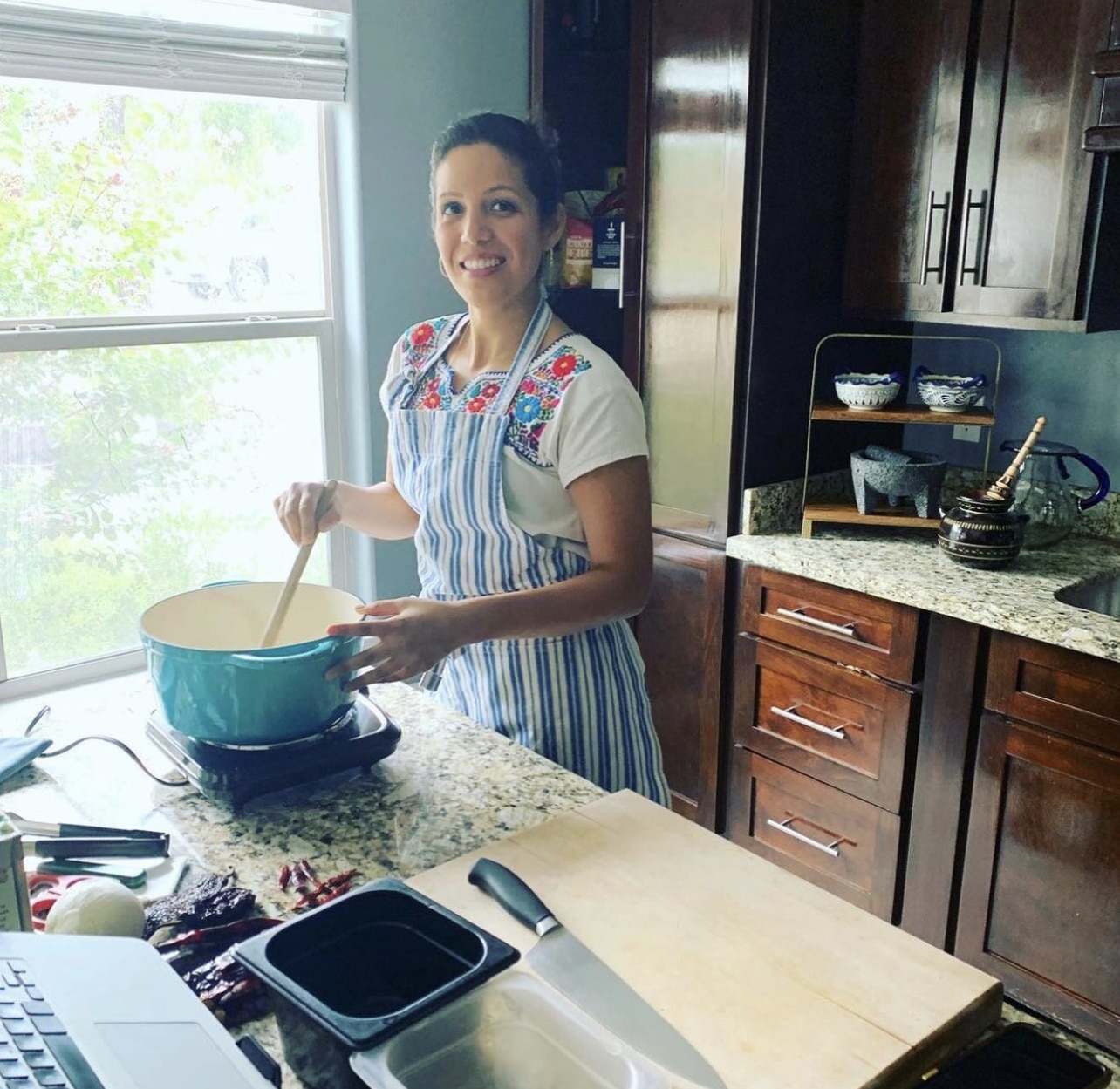 Dora Ramírez cooking in her kitchen